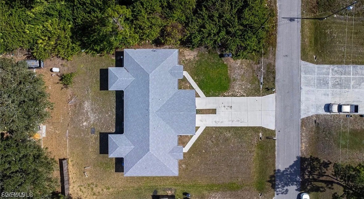 4716 1st Street Southwest Lehigh Acres, FL 33973 - Photo 20 of 20 an aerial view of a house with a yard