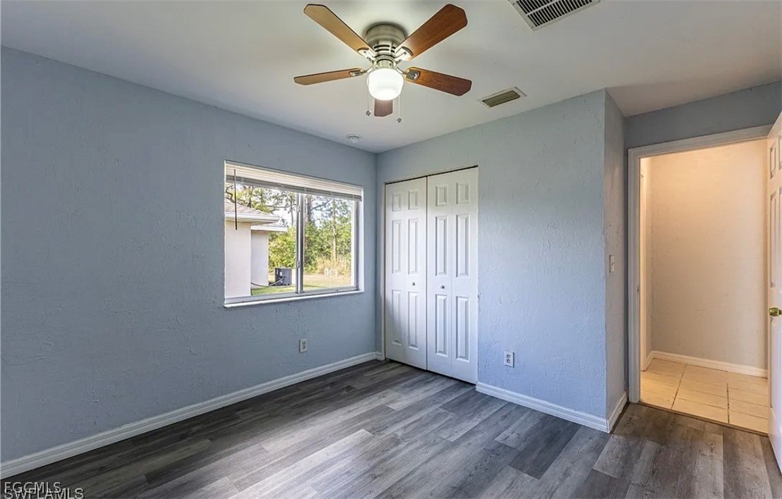 4716 1st Street Southwest Lehigh Acres, FL 33973 - Photo 4 of 20 a view of an empty room with window and wooden floor