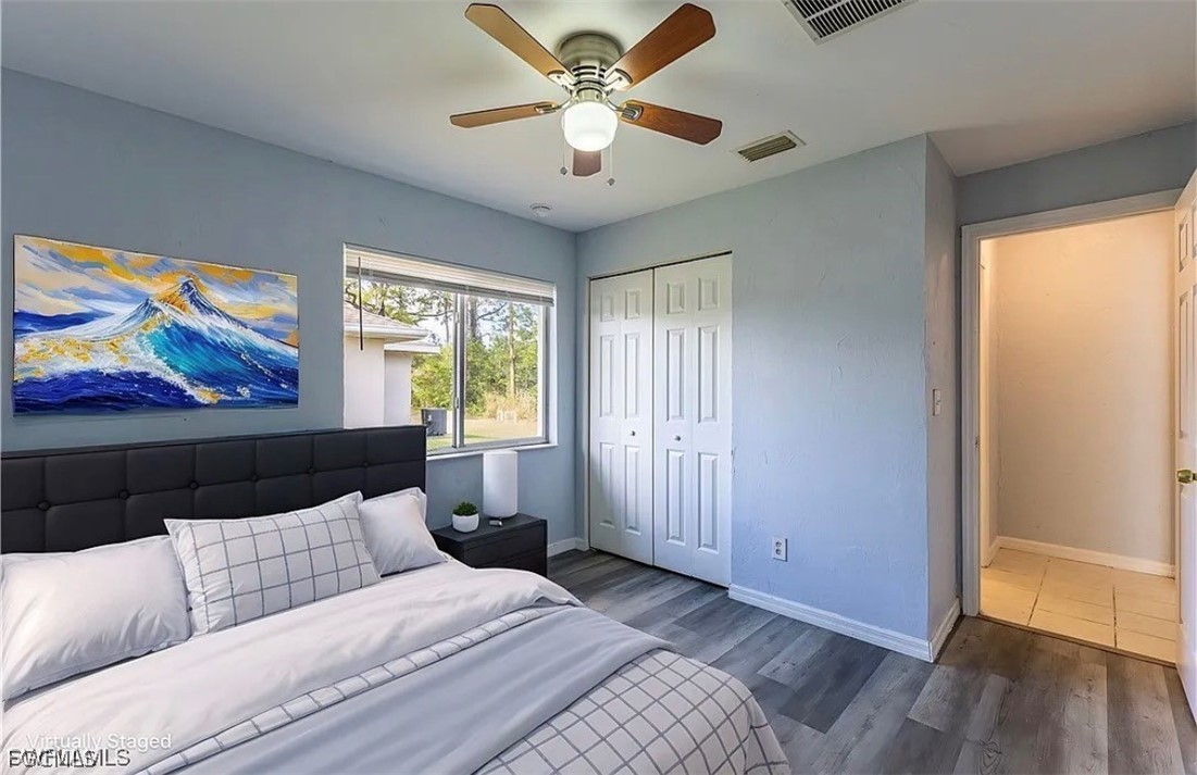4716 1st Street Southwest Lehigh Acres, FL 33973 - Photo 5 of 20 a bedroom with a bed and a painting on the wall