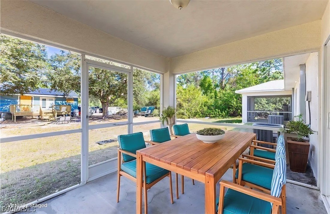 4716 1st Street Southwest Lehigh Acres, FL 33973 - Photo 6 of 20 a view of a patio with a table chairs and a backyard