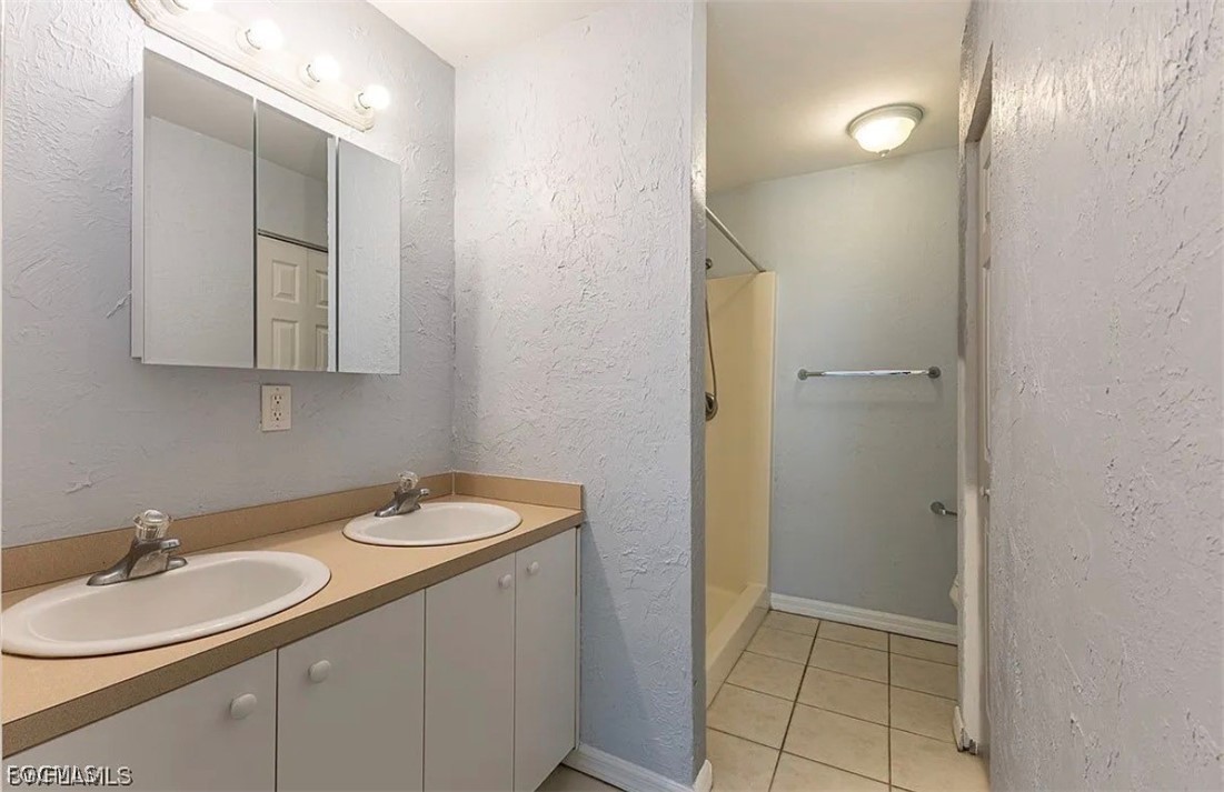 4716 1st Street Southwest Lehigh Acres, FL 33973 - Photo 9 of 20 a bathroom with a sink and a mirror