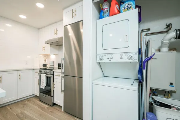 a kitchen with a refrigerator and a stove top oven