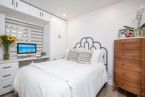 a bedroom with a bed and a television