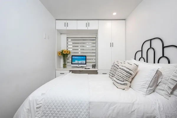 a bedroom with a bed a table and a fireplace