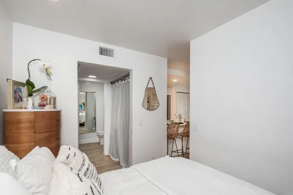 a bedroom with a bed and a dresser