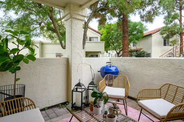 a view of a chairs and table in backyard