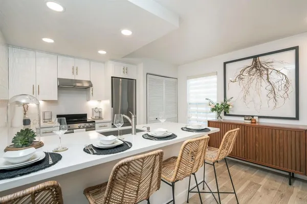 a kitchen with stainless steel appliances kitchen island granite countertop a sink and cabinets
