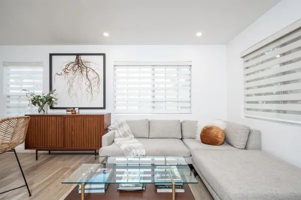 a living room with furniture and wall paintings