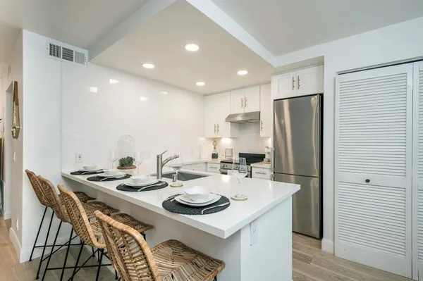 a kitchen with refrigerator and cabinets