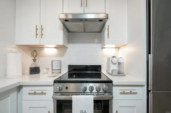 a stove top oven sitting inside of a kitchen
