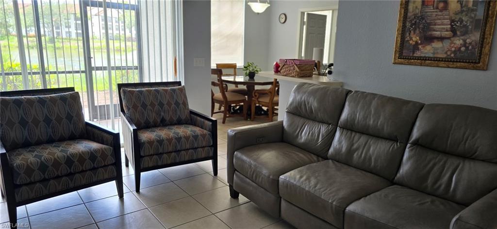 7965 Preserve Circle, Unit 716 Naples, FL 34119 - Photo 4 of 9 a living room with furniture and a large window