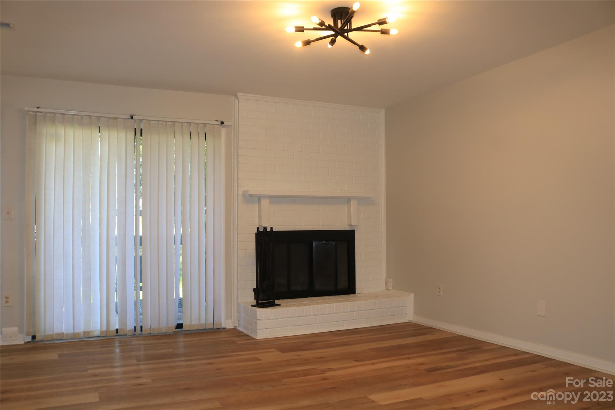 11011 Harrowfield Road Charlotte, NC 28226 - Photo 13 of 24 a view of a livingroom with wooden floor and a fireplace