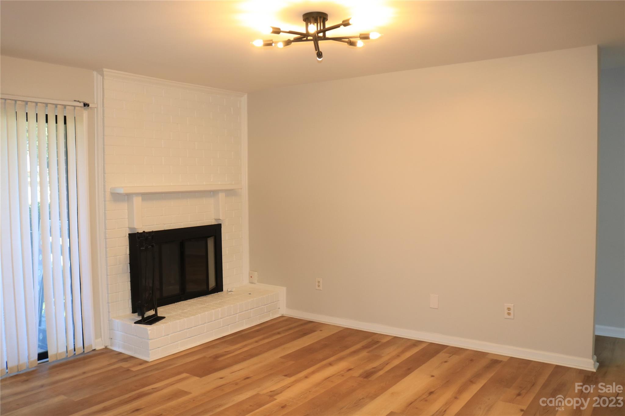 11011 Harrowfield Road Charlotte, NC 28226 - Photo 14 of 24 a view of an empty room with wooden floor and a window