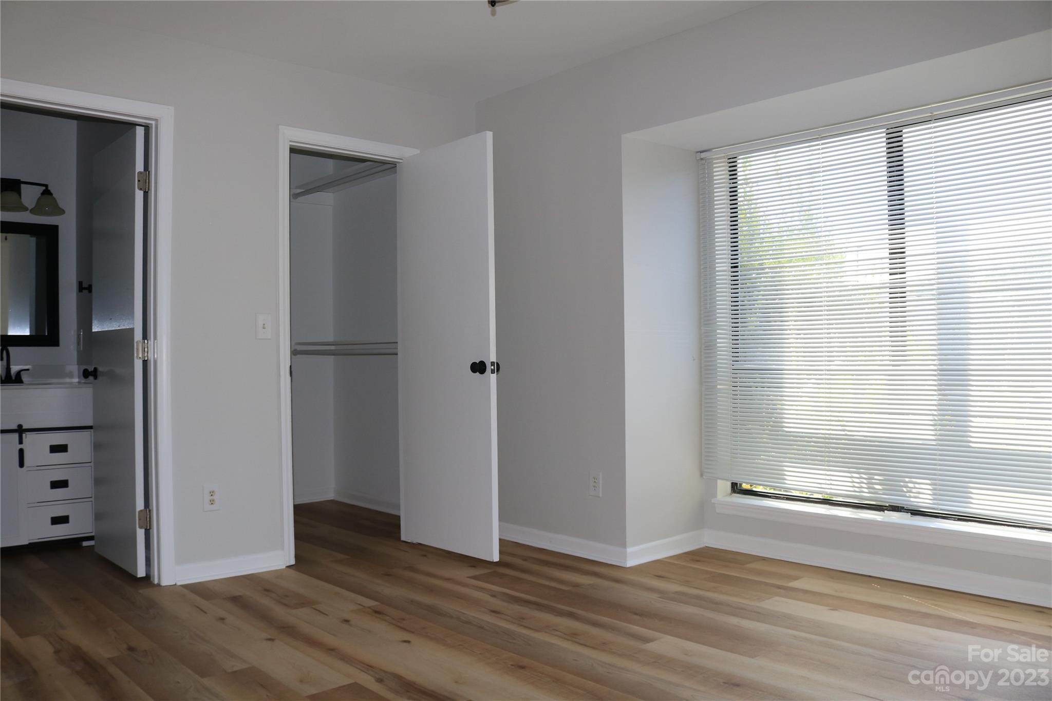 11011 Harrowfield Road Charlotte, NC 28226 - Photo 17 of 24 a view of an empty room with wooden floor and a window
