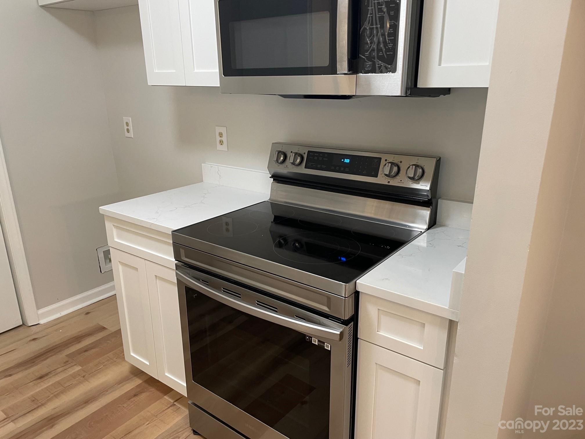 11011 Harrowfield Road Charlotte, NC 28226 - Photo 5 of 24 a stove top oven sitting inside of a kitchen