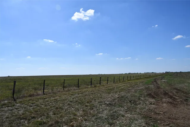 a view of a field with an ocean