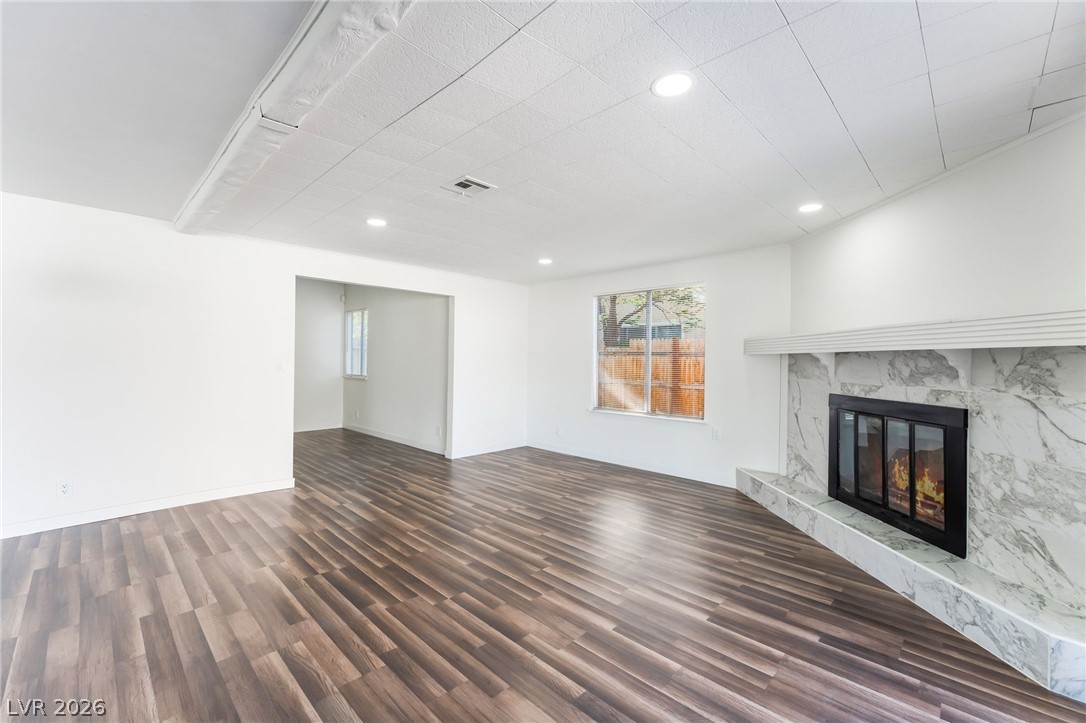 3597 Bronco Road Las Vegas, NV 89103 - Photo 14 of 43 great/ living room featuring dark wood-style flooring, a fireplace, and recessed lighting