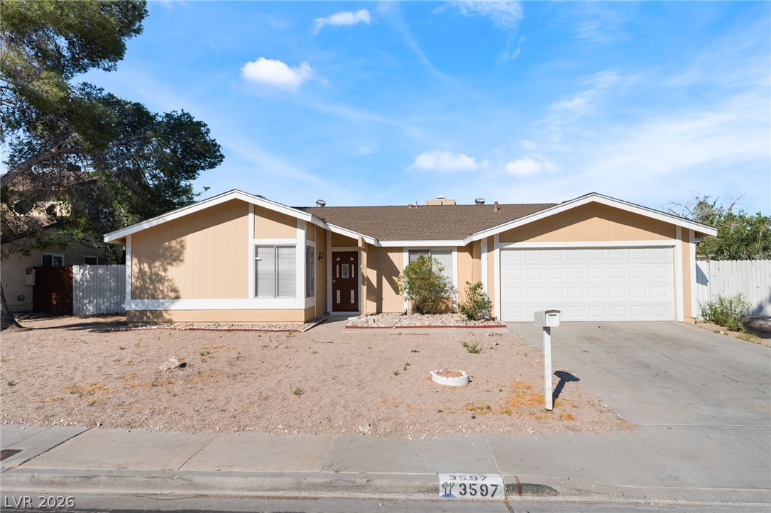 Single story home featuring a garage and concrete driveway