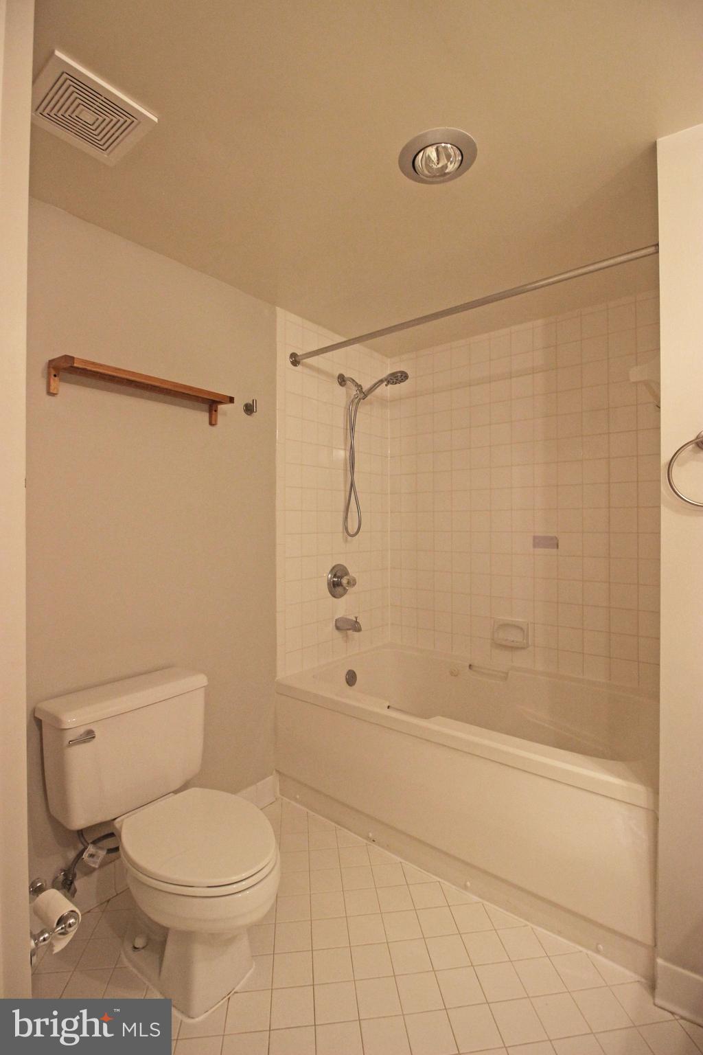 1045 North Utah Street, Unit 108 Arlington, VA 22203 - Photo 17 of 22 a bathroom with a toilet and shower