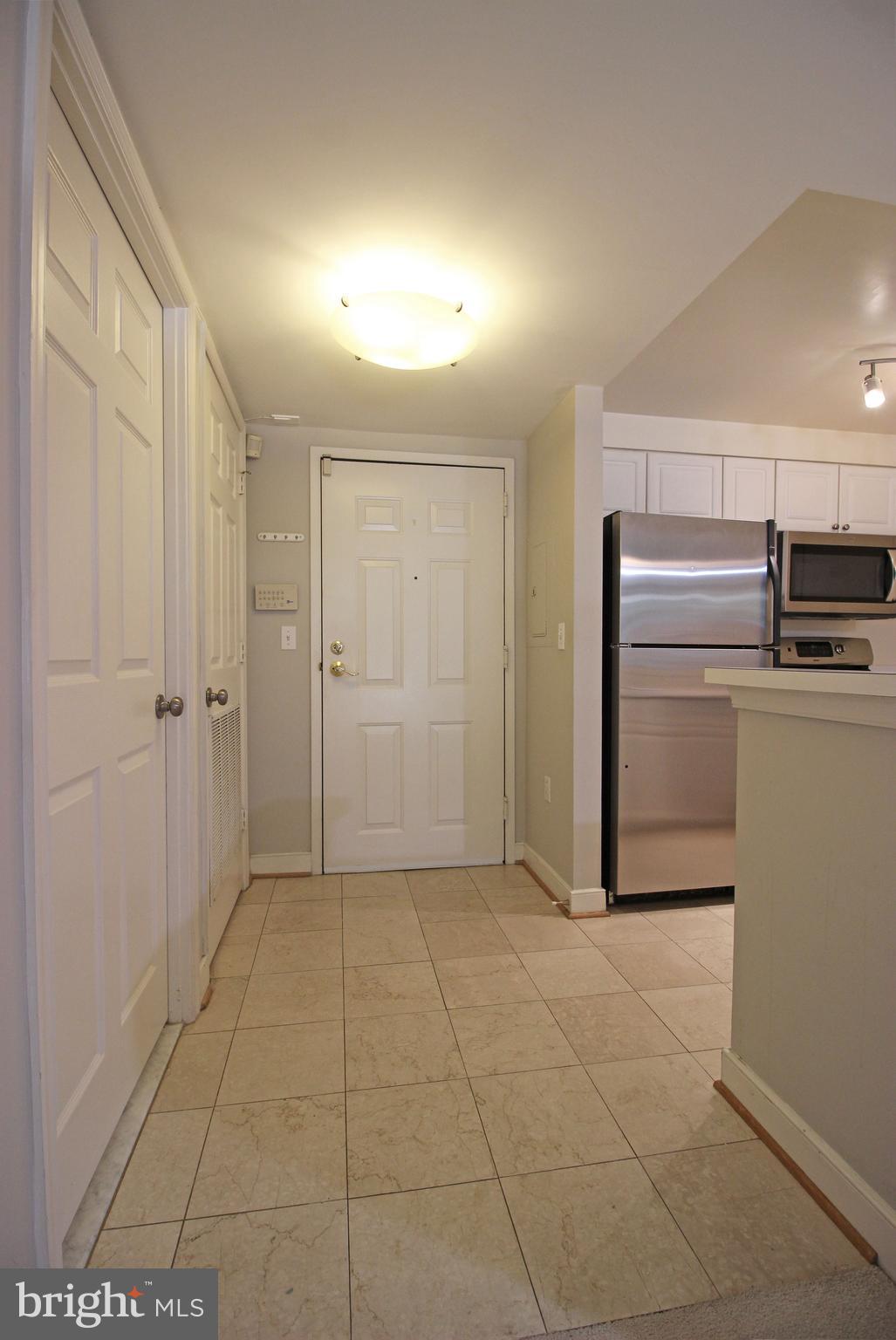 1045 North Utah Street, Unit 108 Arlington, VA 22203 - Photo 19 of 22 a view of a refrigerator in kitchen and an empty room