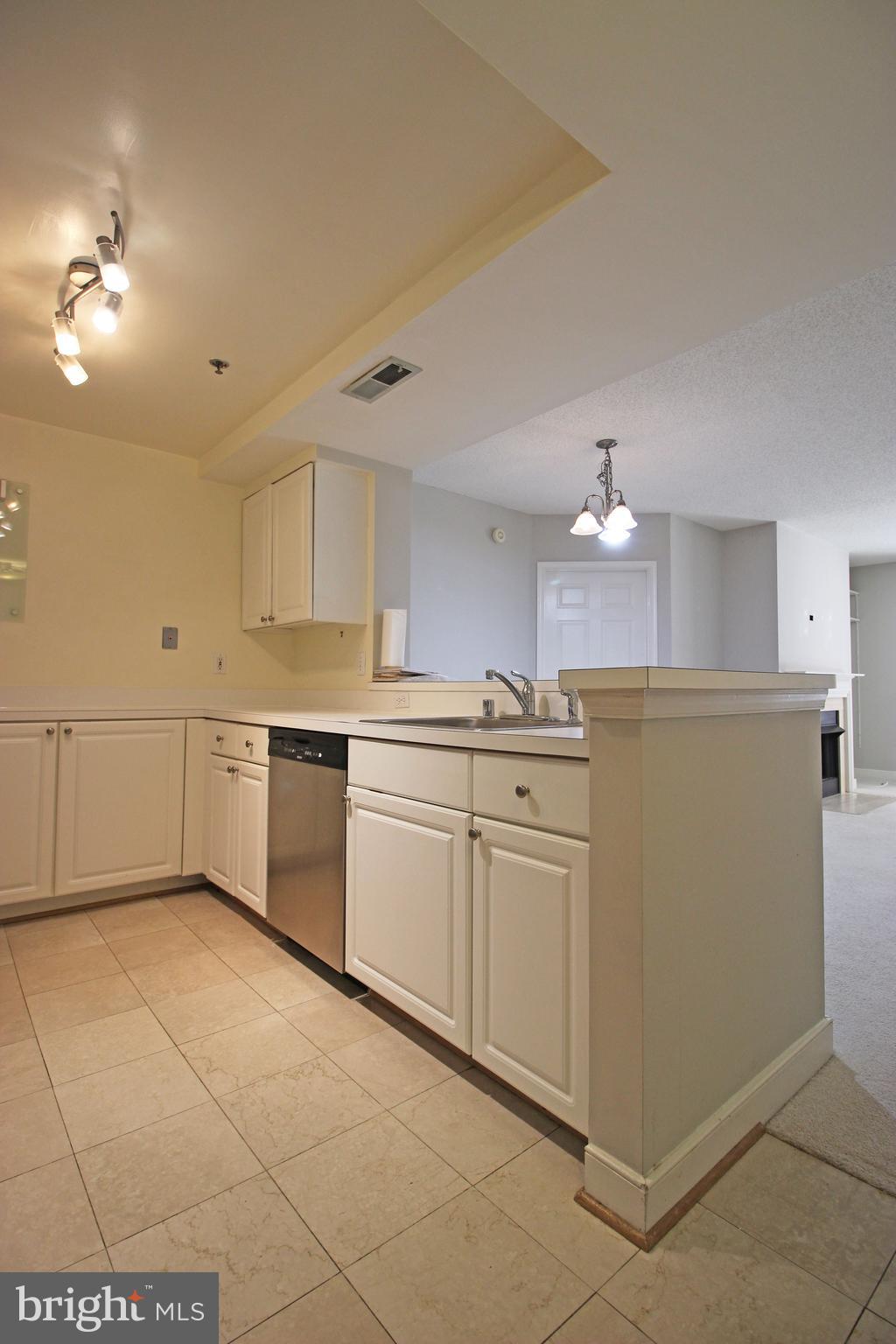 1045 North Utah Street, Unit 108 Arlington, VA 22203 - Photo 3 of 22 a kitchen with cabinets and white appliances