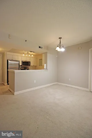 a view of a livingroom with a kitchen