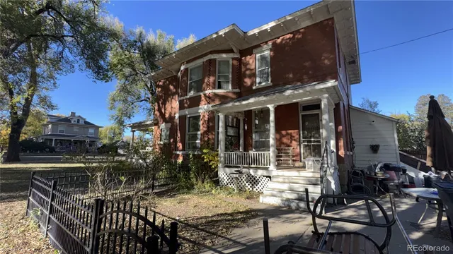 a view of a house with backyard porch and sitting area