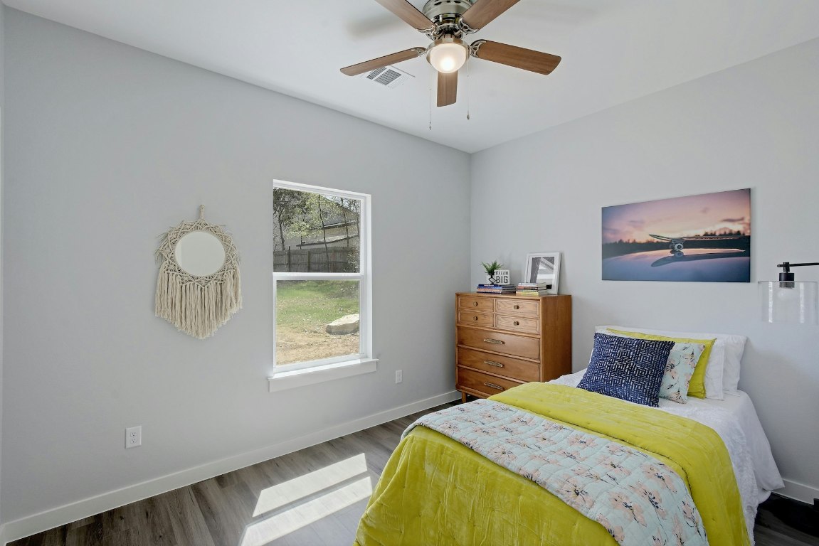 14922 Running Deer Trail Austin, TX 78734 - Photo 27 of 31 a bedroom with a bed and a chandelier