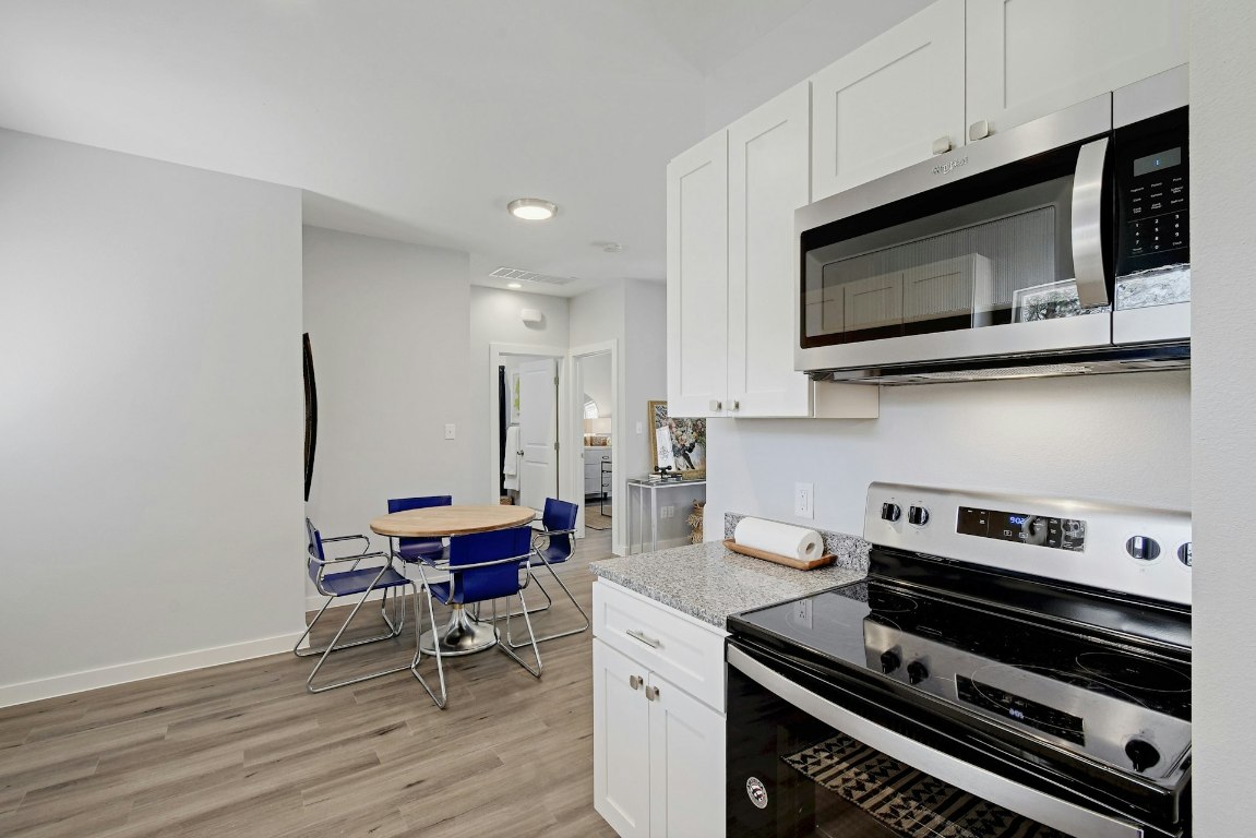 14922 Running Deer Trail Austin, TX 78734 - Photo 19 of 31 a kitchen with a stove and a microwave