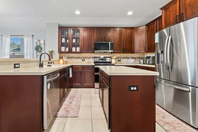 a kitchen with stainless steel appliances a stove and a microwave