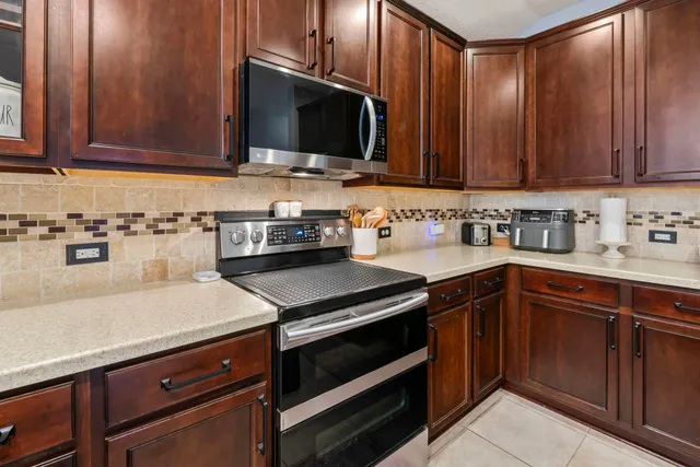a kitchen with a sink a counter space and cabinets