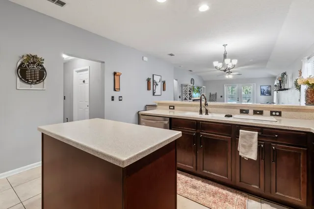 a living room with furniture a dining table and a chandelier