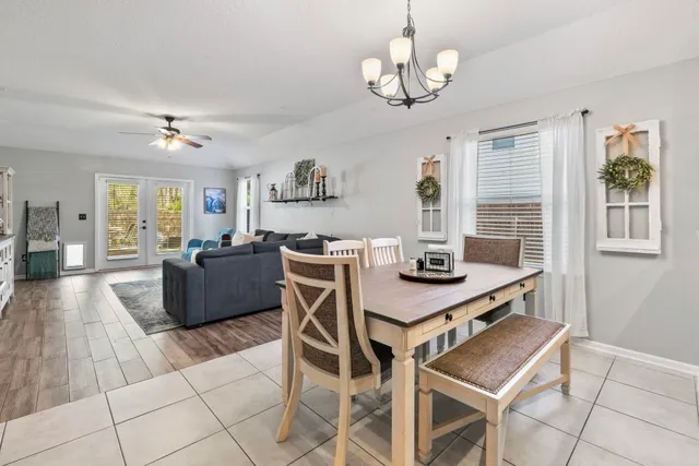 a view of a dining room with furniture and a chandelier