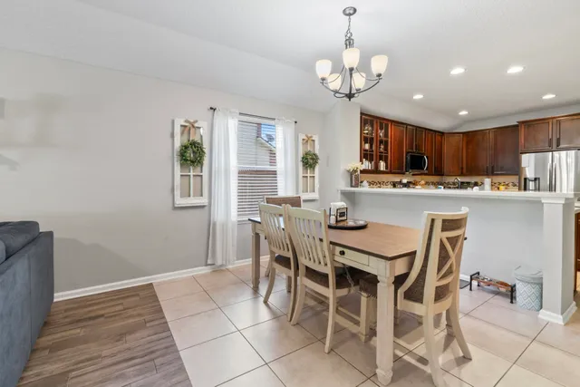 a view of a dining room with furniture and a chandelier
