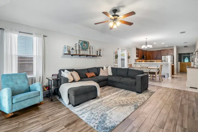 a living room with furniture and a kitchen view
