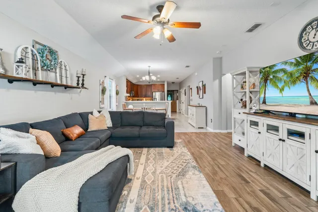 a bedroom with a bed a mirror and a flat tv screen on dresser
