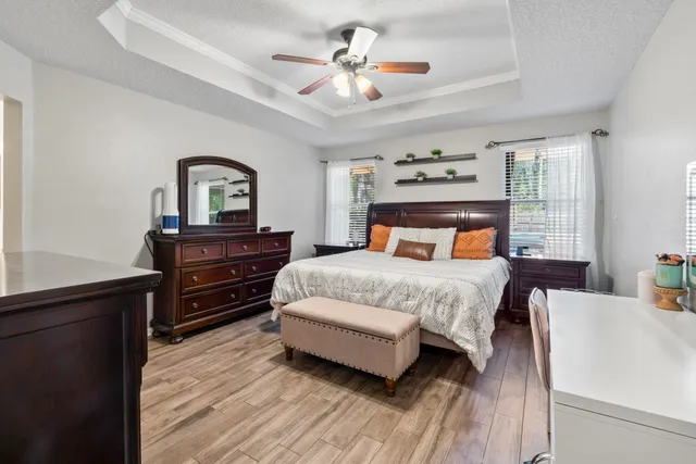 a bedroom with a bed and wooden floor