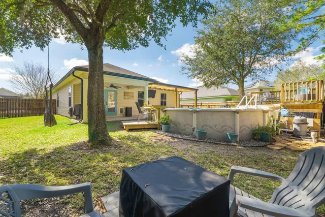 a view of an empty room with furniture and windows