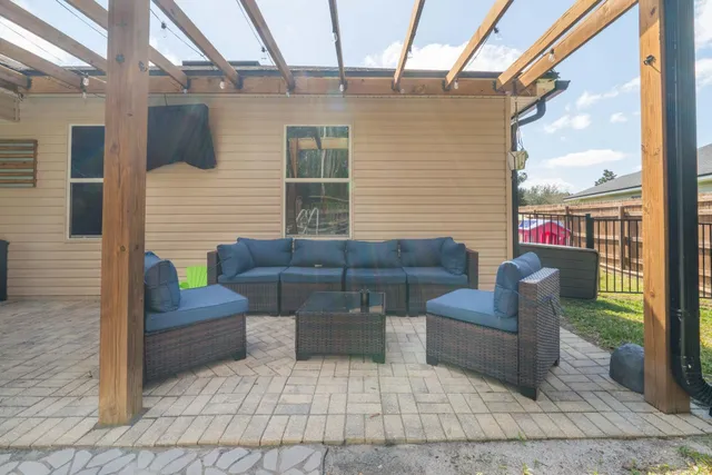a view of a house with backyard porch and sitting area