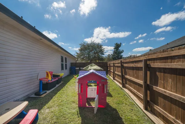 a view of a house with a yard and garage