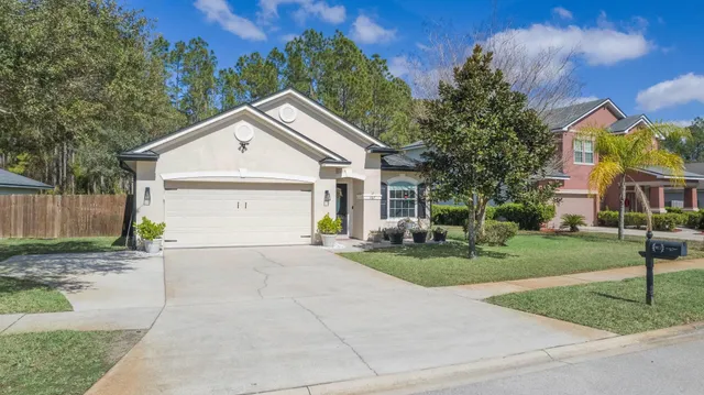 a front view of a house with a yard and porch