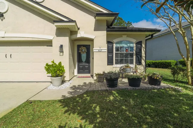 a view of a house with porch and garden