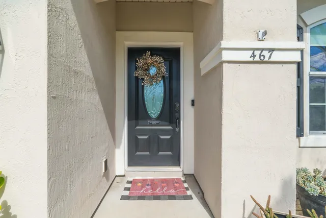 a view of a hallway with wooden floor and windows