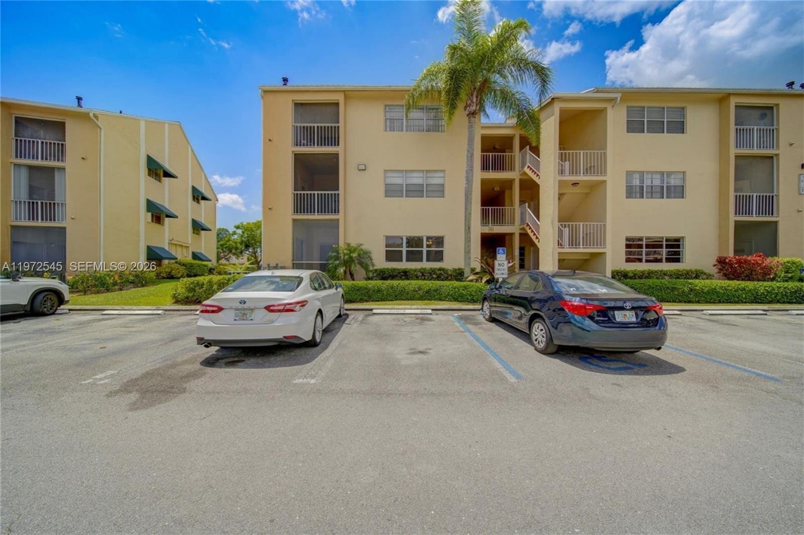 15285 Southwest 107th Lane, Unit 201 Miami, FL 33196 - Photo 12 of 28 a car parked in front of a building