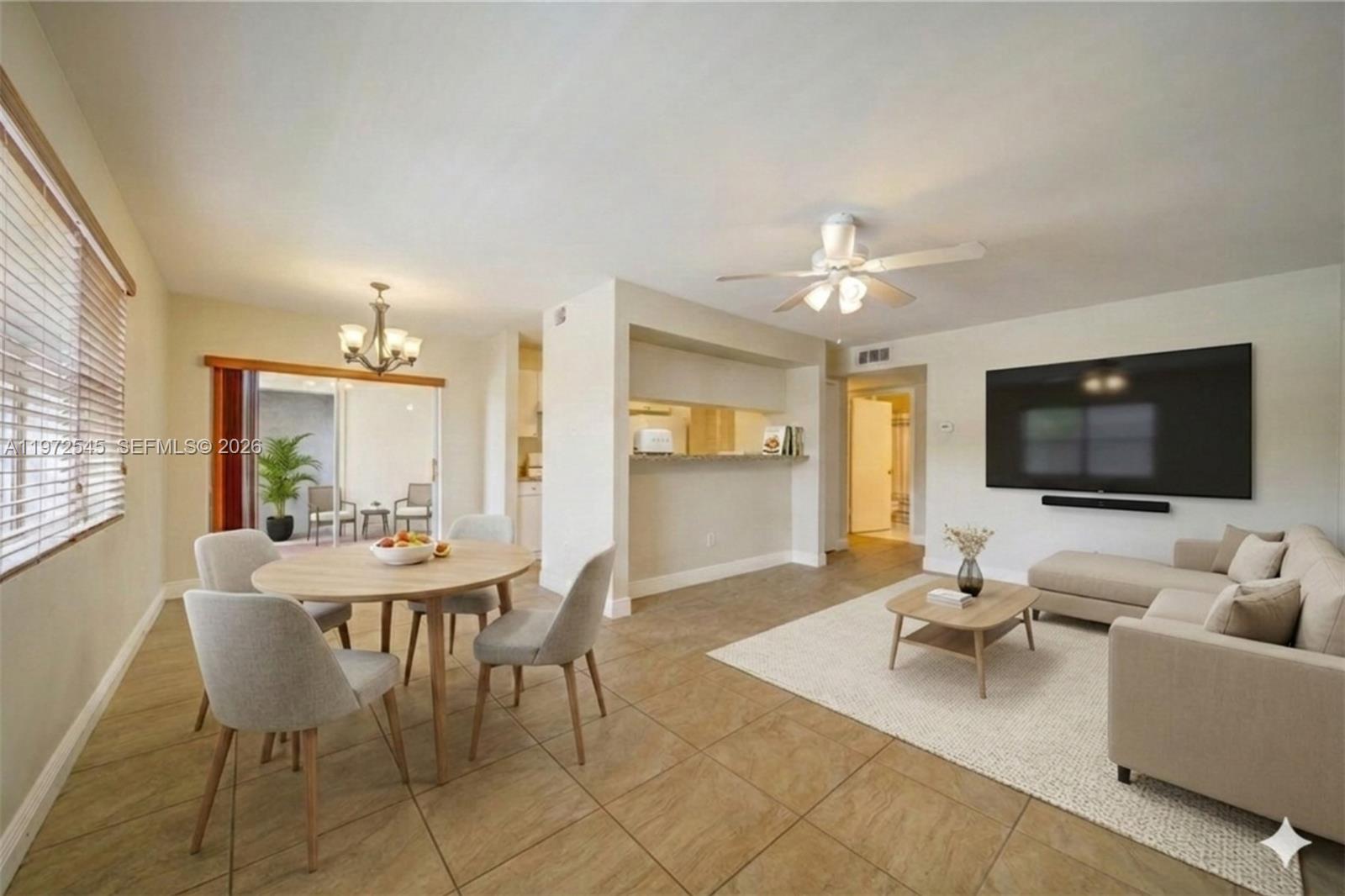 15285 Southwest 107th Lane, Unit 201 Miami, FL 33196 - Photo 15 of 28 a living room with furniture and a flat screen tv