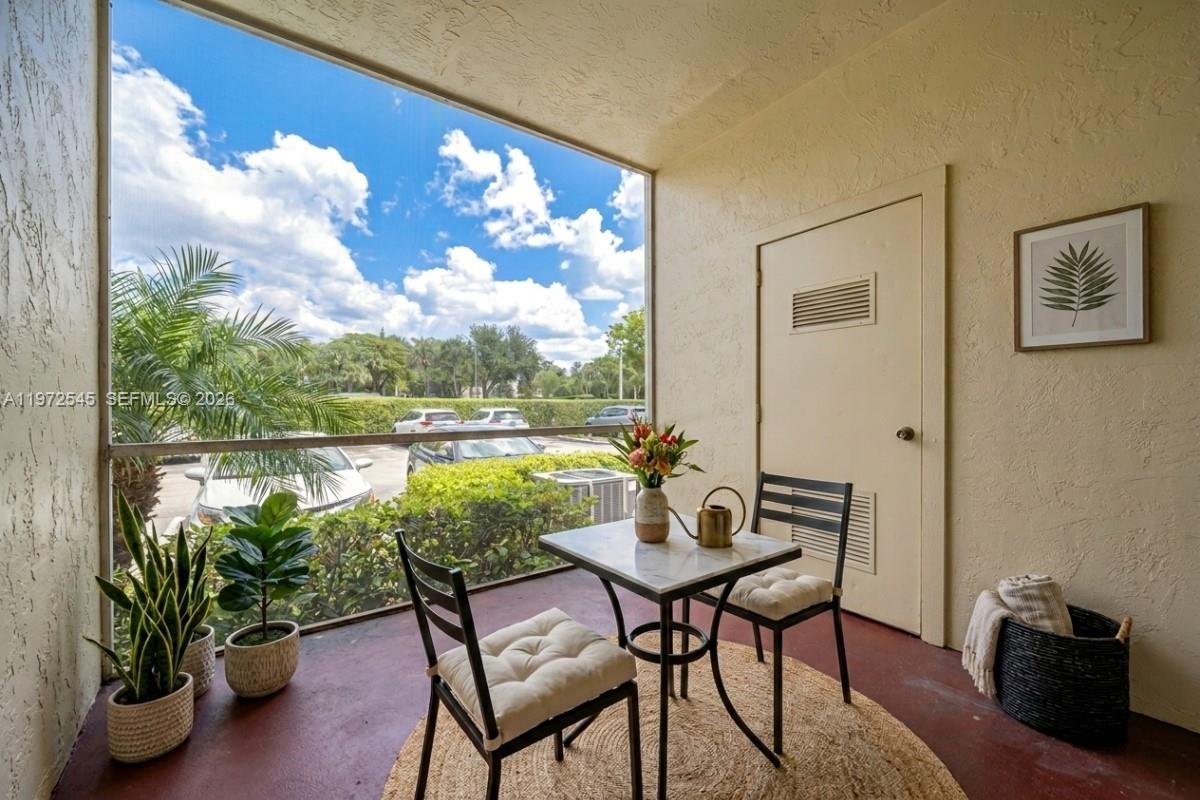 15285 Southwest 107th Lane, Unit 201 Miami, FL 33196 - Photo 16 of 28 a view of a dining room with furniture window and outside view