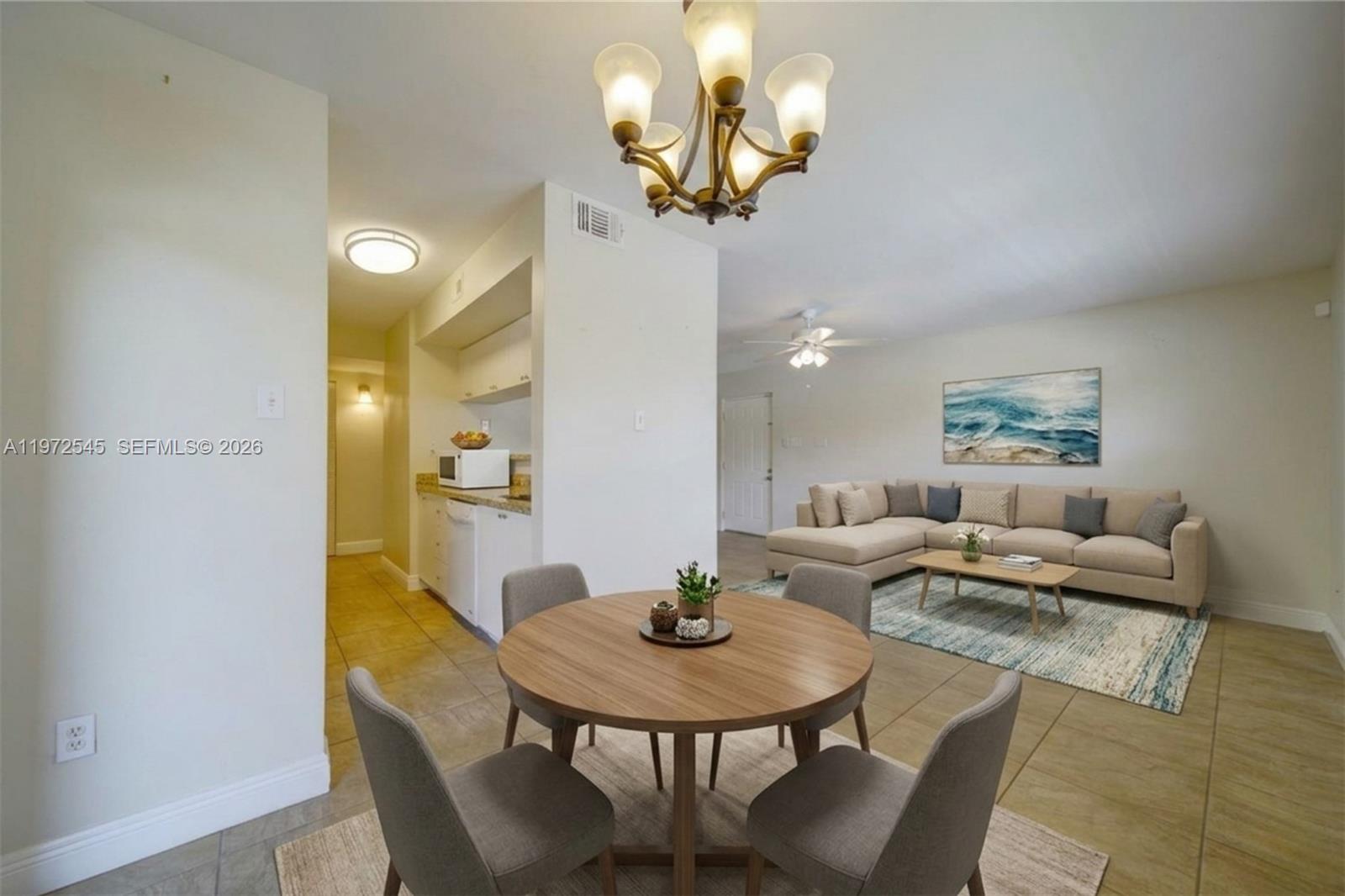 15285 Southwest 107th Lane, Unit 201 Miami, FL 33196 - Photo 18 of 28 a living room with fireplace furniture and a chandelier