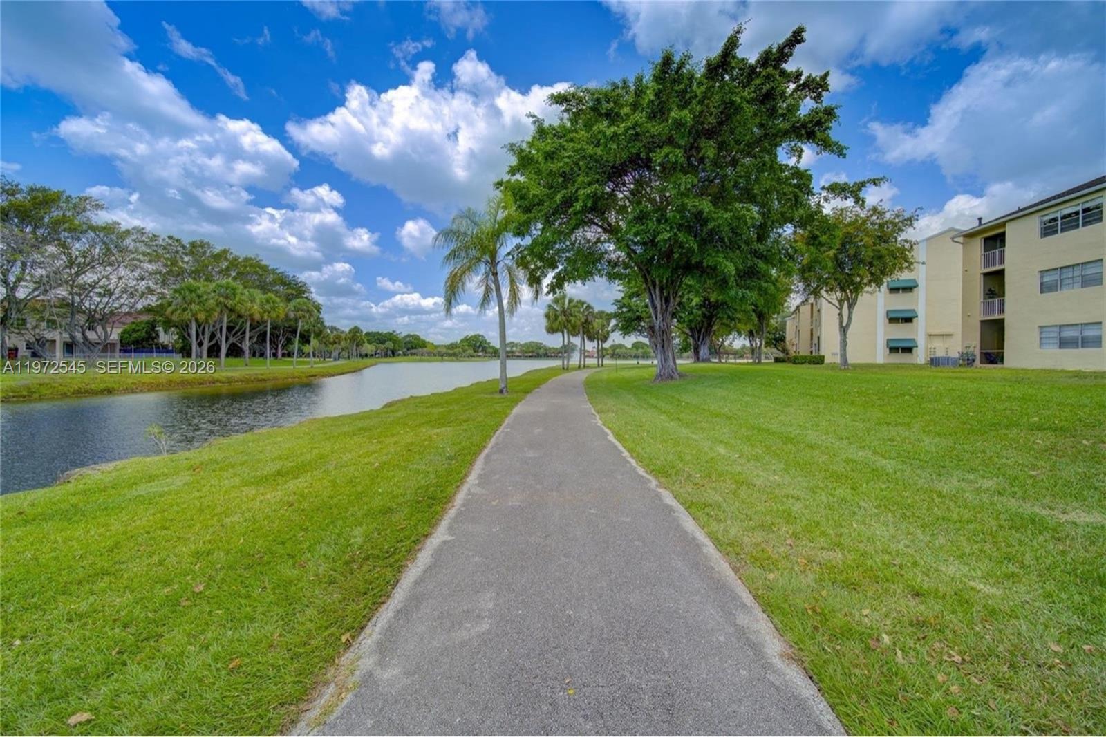 15285 Southwest 107th Lane, Unit 201 Miami, FL 33196 - Photo 19 of 28 a view of a garden with a lake