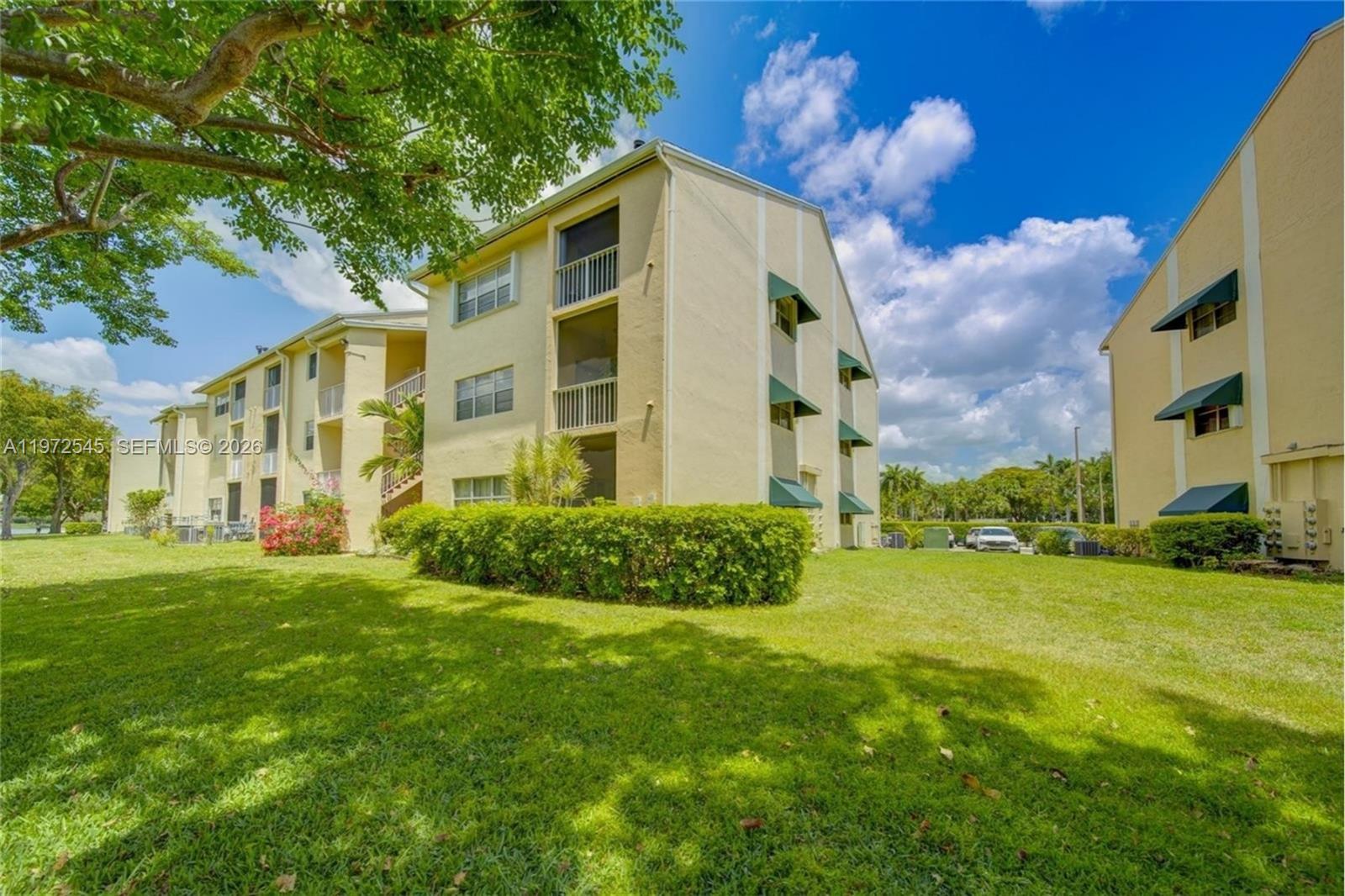 15285 Southwest 107th Lane, Unit 201 Miami, FL 33196 - Photo 23 of 28 a view of a big yard with plants and large trees