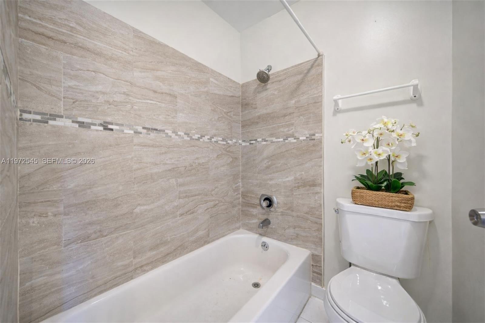 15285 Southwest 107th Lane, Unit 201 Miami, FL 33196 - Photo 7 of 28 a bathroom with a toilet and a bathtub